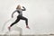 One young woman smiling happy, jumping in mid-air,