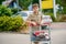 onfident School Boy Pushes the Shopping Cart Through a Bustling Supermarket. Handsome Teenager Gathers Groceries and