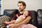 Ð¡onfused young father does not know how to comforting a crying newborn baby. Colic in the baby