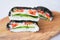 Onigirazu, vegan sushi sandwich with vegetables cucumber, pepper, spinach and tofu. Trend Japanese food. Healthy food concept