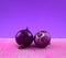 Onion bulbs purple still life, fine art style. Colorful beautiful vegetable culinary on pink grunge against purple background.