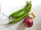 Onion and chilly and garlic on white background. Kanda lasun mirchi image. Red onion and green chillies and garlic.