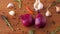 Onion, garlic, chili pepper and rosemary on table