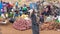 Onion market in Uganda. Women in colorful dresses selling different onions on street market.