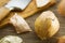 Onion peelings, knife and wood cutting board in the background