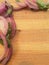 Onion pieces border on wooden background