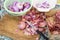 Onion skin being prepared peeled with knife, chopping board cola