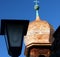 Onion tower with copper top of a medieval wooden church against a blue sky