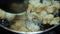 Onion vada with hot oil boiling in cooking pan closeup view, Indian dish making in a traditional home method , some area this is c