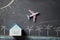 Online airplane tickets reservation. Booking accommodation. Miniature of house mockup with copy space.