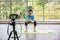 Online Asian coach squat exercise live record by mirrorless camera