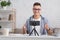 Online blogger. Smiling guy in glasses gestures and records video on smartphone