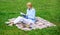 Online business ideas concept. Business picnic concept. Woman with laptop or notebook sit on rug green grass meadow