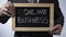 Online business written on blackboard, businessman holding sign, freelance