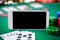 Online casino concept, playing cards, dice chips and smartphone