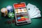 Online casino and gambling concept. Slot machine on smartphone screen, cards, dice and poker chips