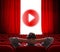 Online cinema screen with open red curtain and play media button in center