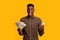 Online credit. Funny young black man holding smartphone and dollar cash