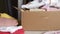 Online delivery of clothes on customer orders, fashion items in a parcel in a box on the table