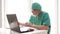 Online doctor. An experienced doctor consults a patient using the laptop. Covid-19 Epidemic.