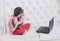 Online education. Girl learns to play guitar at home using laptop.