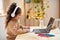 Online Education. Little Arab Girl In Headphones Study With Laptop At Home