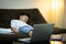 Online education problems,asian schoolboy student sleeping while studying homework online with laptop computer at home,during