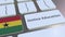 Online Education text and flag of Ghana on the buttons on the computer keyboard. Modern professional training related