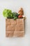 Online grocery healthy food shopping in paper bag, top view