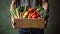 Online grocery shopping and home delivery: hands holding a box full of groceries. Eco friendly responsible lifestyle and shopping