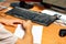 Online learning concept, a young man sits in front of a computer monitor and prepares to write a test task