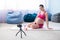 Online lessons for pregnant women. European woman shoots a video fitness lesson on the phone. Waiting for a miracle