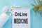 Online medicine-text inscription on a paper Notepad. News information, consultation, remote appointment with a specialist doctor