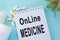 Online medicine-text inscription on a paper Notepad. News information, consultation, remote appointment with a specialist doctor