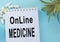 Online medicine-text inscription on a paper Notepad. News information, consultation, remote appointment with a specialist doctor