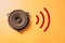 Online music. Musical, media entertainment. Music streaming. Sound speaker on yellow background with wifi waves sign