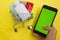 Online pharmacy. Closeup of hands on a phone and a mini shopping trolley with tablets. A woman chooses medicines on the