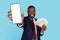 Online Profit. Excited Black Businessman Holding Blank Smartphone And Dollar Cash