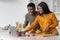 Online Recipe. Joyful black couple using laptop computer in kitchen while cooking