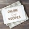 Online recipes. App in smartphone. Brown wooden background