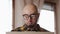Online remote work. Bearded bald young handsome Caucasian man wearing eyeglasses working at laptop. Close up view at