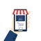 Online shopping concept 25 % off sale. A male hand holds a smartphone with a shopping cart. Ecommerce, order delivery service,