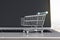 Online shopping concept with mini trolley store on laptop keyboard