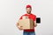 Online shopping, delivery, technology and lifestyle concept - smiling delivery man presenting tablet and holding boxes