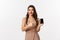 Online shopping. Good-looking woman with red lipstick, luxury dress, pointing finger at mobile screen, showing internet
