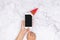 Online shopping for seasonal gifts during Christmas holiday. woman hand use finger touch on mobile phone button with blank screen
