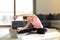 Online sport fitness yoga training. woman and doing exercises on yoga mat with laptop at home