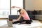 Online sport fitness yoga training. woman doing exercises on yoga mat with laptop with online training at home