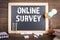 ONLINE SURVEY concept. Chalkboard, books, notebooks and colored balloons