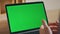 Online teacher talking green screen laptop web camera sitting home close up.